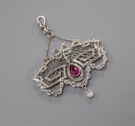 A Belle Epoque pierced white metal, ruby and diamond set drop pendant, width 39mm.
